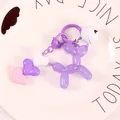 Macro view of purple jelly balloon dog keychain with heart charms and bell in ceramic tray - Purple (yc5257)