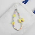 Detail of macaron beaded bag charm with large yellow bow and pastel colorful beads - Yellow