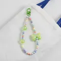 Detail of colorful macaron beaded charm with green butterfly pendant and lobster clasp - Green