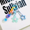 Macro view of dopamine-style acrylic keychain with colorful flower and star charms - Blue