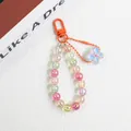 Macro shot of colorful acrylic beads keychain with orange clasp and butterfly pendant - Butterfly