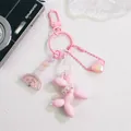 Detail view of pink balloon dog keychain with pearls, heart charm and rainbow beads - Pink
