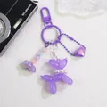 Detail of purple balloon dog keychain with heart pendant, colorful beads and pearl necklace - Purple