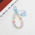 Macro shot of colorful iridescent acrylic beads keychain with blue smiley face pendant - Smiley Face