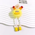Detail of yellow plush monster keychain with big eyes and orange tentacles on a white stand - Yellow Monster Style (yc5281-4)