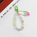 Detail of colorful acrylic beaded keychain with macaron beads and a pink strawberry charm - Strawberry