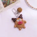 Detail shot of a brown monster keychain with red lips and a soft brown pom-pom charm - Brown (yc5288-2)