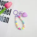 Pastelkleurige kralen polsband met paarse hart hanger en strik voor sleutels - Paars