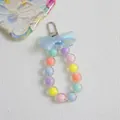 Pastel macaron beaded phone charm with blue bow and silver lobster clasp accessory - Blue
