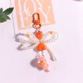 Detailed close-up of a pearl bow keychain featuring orange hearts and a faceted ball pendant - Orange Bow Style(yc5294-4)