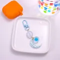 Close-up of cute cartoon cloud and pearlescent moon keychain with blue D-ring clasp - Blue