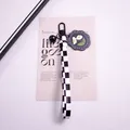 Close-up of checkerboard ribbon keychain with daisy pendant and black metal clasp - Double Daisies (yc5305-3)
