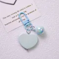 Detail of light blue heart keychain with iridescent bead and matching lobster clasp accessory - Blue