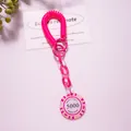 Macro detail of bright pink coil bracelet keychain with Monte Carlo Poker chip charm - Rose Pink (Value 5000)