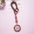 Macro shot of poker chip keychain with brown spring coil and acrylic chain links - Khaki (Value 2000)