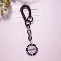 Detail of a black spiral cord keychain with a Monte Carlo poker chip acrylic pendant - Black (Value 10,000)
