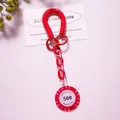 Macro view of red poker chip keychain with spring coil and acrylic chain links - Red (Value 500)