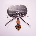 Dettaglio portachiavi a cuore leopardato con pompon di pelliccia e fiocco intrecciato - Stile Fiocco Stampa Leopardata