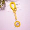 Detailed view of yellow spring keychain with Monte Carlo Poker chip and acrylic chain - Yellow (Value 1000)
