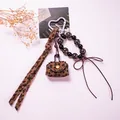 Detail of leopard print mini bag charm with heart clasp, beads and brown bow accent - Leopard Dark Coffee