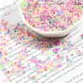Mixed macaron glass seed beads spilling from a white porcelain bowl for DIY jewelry - Mixed Colors