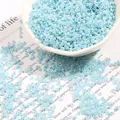 Light blue glass seed beads in a white bowl for DIY jewelry and bracelet making - Light Blue