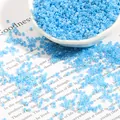 Light blue cream seed beads in a white bowl for DIY jewelry and bracelet making - Lake Blue