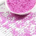 Pale pink purple transparent glass seed beads in a white bowl for DIY jewelry making - Light Rose