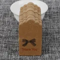 Brown kraft paper gift tags with bow design and Thank You text for DIY packaging - Kraft Scalloped Bow Style
