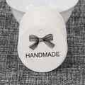 White round gift tags with black bow and handmade text for DIY packaging craft projects - Handmade Bow Round Style