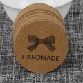 Round brown kraft paper tags featuring a black handmade bow design for DIY jewelry crafts - Kraft Handmade Bow Round Style