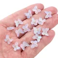 Mini aurora purple butterfly glass charms for DIY jewelry making shown in hand - 10×11mm / Blue Pink Blue Tears Effect