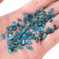 Irregular blue glass stone beads for DIY jewelry making held in hand for scale - Blue Apatite
