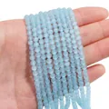Light blue cat-eye beads strands for DIY jewelry making displayed on a hand palm - 4mm Blue (1 Strand/Pack, approx. 95 Beads)