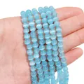 Light blue cat eye stone round beads for DIY jewelry making held in a hand - 6mm Blue (1 Strand/Pack, approx. 65 Beads)