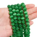 Emerald green cat eye round beads strands for DIY jewelry making held in hand - 10mm Green (1 Strand/Pack, approx. 40 Beads)