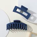 Detail view of two dark blue matte hair claws in rectangular and half-round shapes - Dark Blue