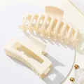 Detailweergave van twee crèmekleurige matte haarklemmen met gladde, afgeronde tanden - Beige