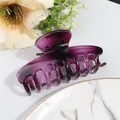 Detail of a large translucent purple resin hair claw clip with interlocking teeth design - Purple