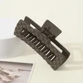 Close-up of mocha brown hair claw clip with a matte quilted texture and large square design - Dark Coffee
