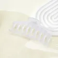 Close-up of a large 11cm frosted translucent hair claw clip with cross comb teeth - White