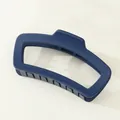 Detail shot of the matte dark blue rectangular cutout hair claw clip with firm teeth - Dark Blue