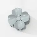 Detailed top view of a glossy flower-shaped hair claw clip in a dusty blue Morandi color - Four Petal Morandi Grey Blue (Blue) / Blue