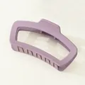 Macro view of matte purple square hair claw clip with geometric cutout design on beige background - Violet