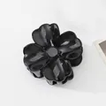 Detailed view of a glossy black camellia flower hair claw clip for elegant hairstyling - Five Petal Camellia Glossy (Black) / Black