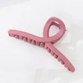 Macro detail of large matte pink ribbon hair claw clip for women on white background - Bright Pink