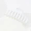 Detail view of a large matte white hair claw clip with a curved multi-tooth design - White