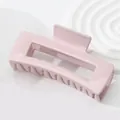 Macro shot of the rectangular light pink glossy claw clip with smooth resin surface - Light Pink