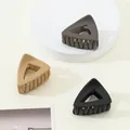 Three matte mini hair claws in black, khaki, and grey colors on a minimalist display - Neutral Triangle (376)