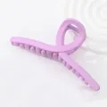 Matte light purple 13cm oversized hair claw clip with cross twist design on white background - Pink